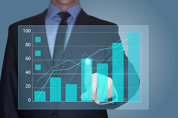 Image showing Businessman Touching a Graph Indicating Growth. business concept 