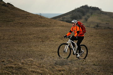 Image showing Man cyclist with backpack riding the bicycle