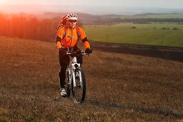 Image showing Man cyclist with backpack riding the bicycle