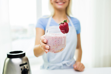 Image showing close up of woman holding glass with fruit shake