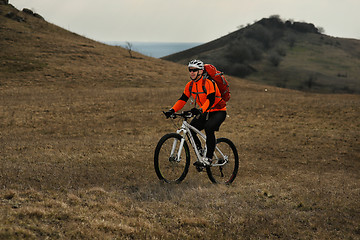 Image showing Man cyclist with backpack riding the bicycle