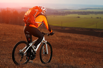 Image showing Man cyclist with backpack riding the bicycle