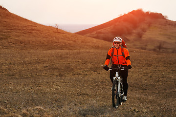 Image showing Man cyclist with backpack riding the bicycle