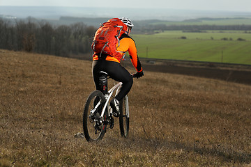 Image showing Man cyclist with backpack riding the bicycle