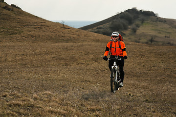 Image showing Man cyclist with backpack riding the bicycle