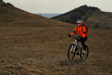 Image showing Man cyclist with backpack riding the bicycle