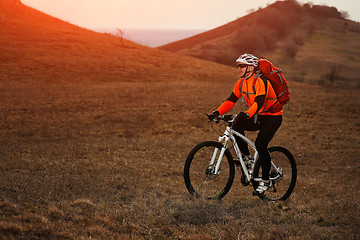 Image showing Man cyclist with backpack riding the bicycle