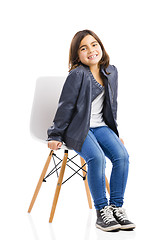 Image showing Beautiful young girl sitting on a chair