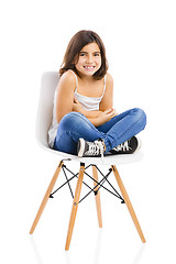 Image showing Beautiful young girl sitting on a chair