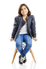 Image showing Beautiful young girl sitting on a chair