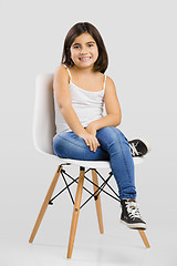 Image showing Beautiful young girl sitting on a chair