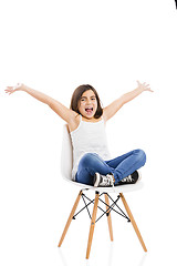 Image showing Beautiful young girl sitting on a chair