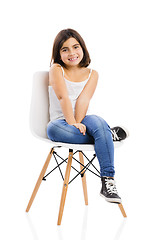 Image showing Beautiful young girl sitting on a chair