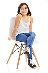 Image showing Beautiful young girl sitting on a chair