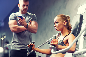 Image showing man and woman flexing muscles on gym machine