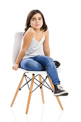 Image showing Beautiful young girl sitting on a chair