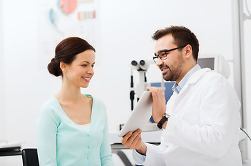 Image showing optician with tablet pc and patient at eye clinic