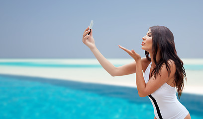 Image showing young woman taking selfie with smartphone