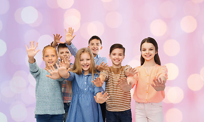 Image showing happy children waving hands