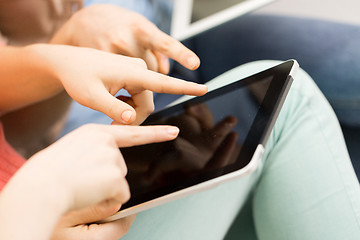 Image showing close up of young women with tablet pc at home