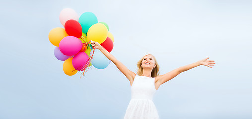 Image showing woman with colorful balloons outside