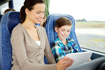 Image showing happy family with tablet pc sitting in travel bus