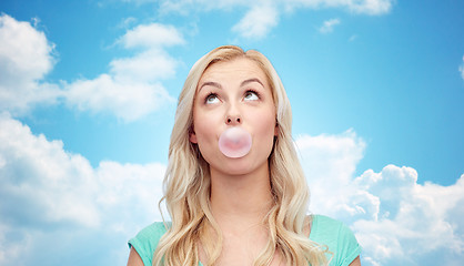 Image showing happy young woman or teenage girl chewing gum