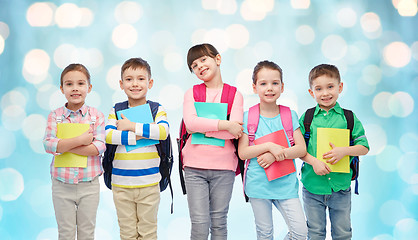 Image showing happy children with school bags and notebooks