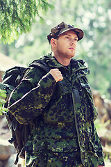 Image showing young soldier with backpack in forest