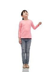 Image showing girl looking up and holding something invisible