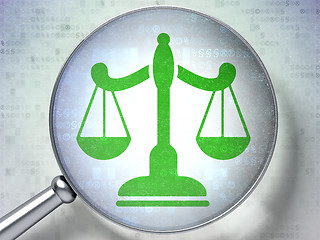 Image showing Law concept: Scales with optical glass on digital background