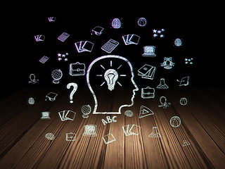 Image showing Learning concept: Head With Lightbulb in grunge dark room