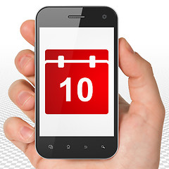 Image showing Time concept: Hand Holding Smartphone with Calendar on display