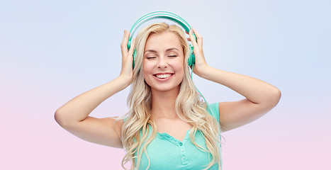 Image showing happy young woman or teenage girl with headphones