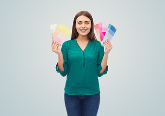 Image showing smiling young woman with color swatches