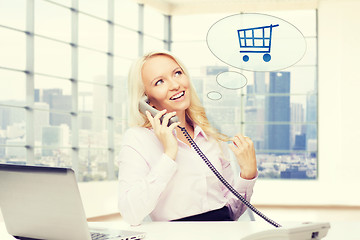 Image showing smiling businesswoman calling on telephone