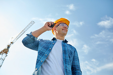 Image showing close up of builder in hardhat with walkie talkie