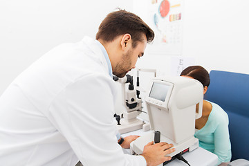 Image showing optician with autorefractor and patient at clinic