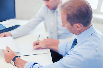 Image showing businessmen with notebook on meeting