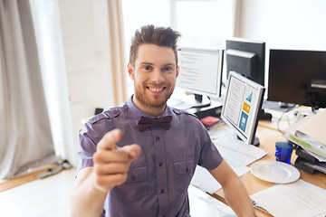 Image showing happy male office worker pointing finger at you