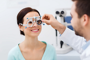 Image showing optician with trial frame and patient at clinic