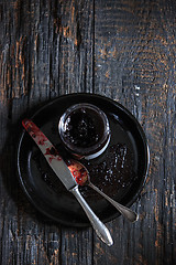 Image showing The top view of fruity jam on black wooden table