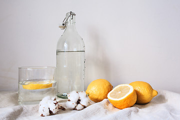 Image showing Tasty cool beverage with lemon on white cotton fabric