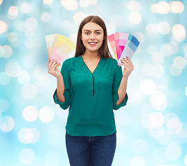 Image showing smiling young woman with color swatches