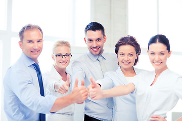 Image showing business team showing thumbs up in office