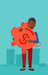 Image showing Man carrying piggy bank.