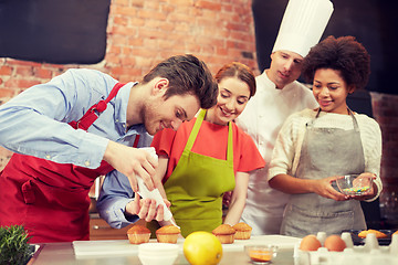 Image showing happy friends and chef cook baking in kitchen