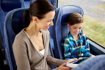 Image showing happy family with tablet pc sitting in travel bus