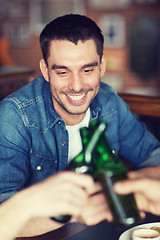 Image showing happy male friends drinking beer at bar or pub