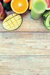 Image showing close up of fresh juice glass and fruits on table